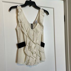 Brand new. Never worn. Gorgeous chiffon like top. Zips in back.